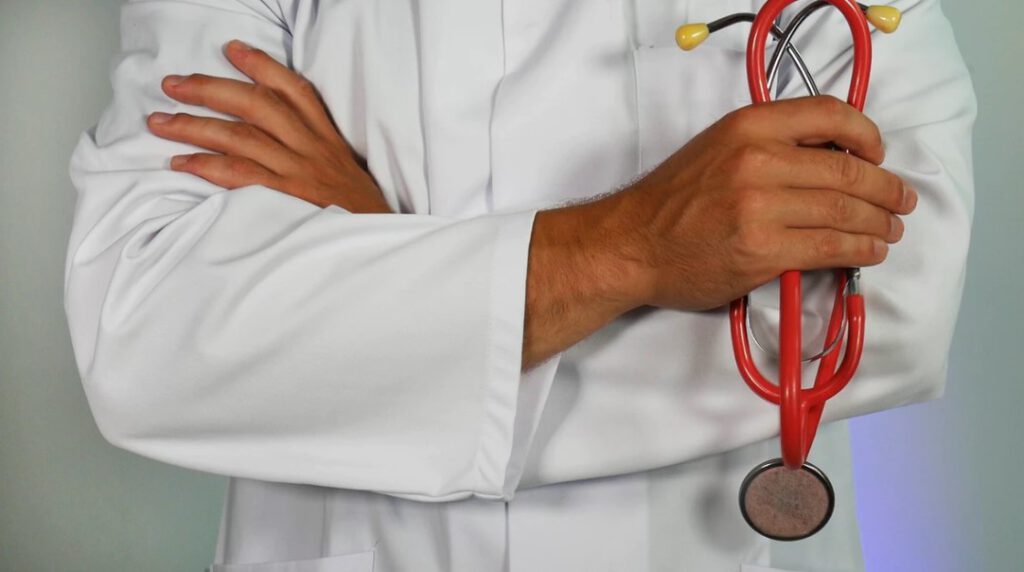 Close up view of male doctor with arms folded